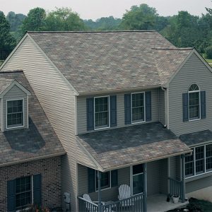A large home with a front porch and new shingle roof